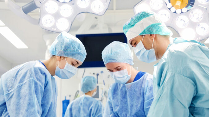 group of surgeons in operating room at hospital