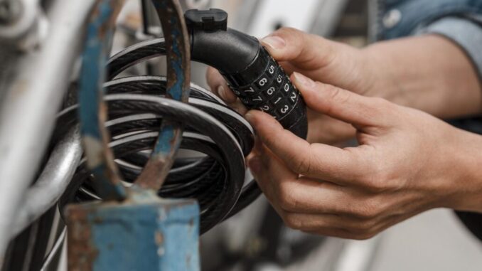 woman putting bike lock