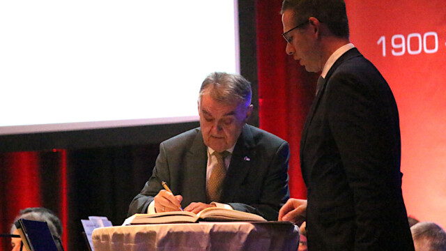 Innenminister Herbert Reul trägt sich ins goldene Buch der Stadt Erkrath ein. Foto: Christian Zimmer